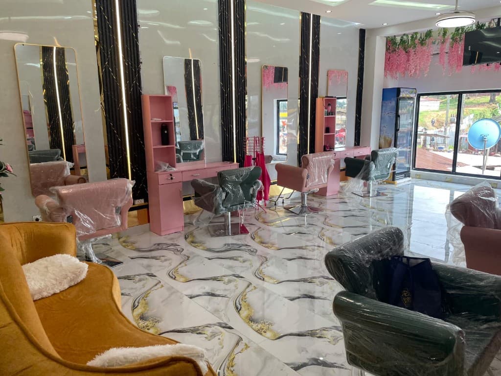 Liberian Beauty Salon interior with pink styling stations and mirrors
